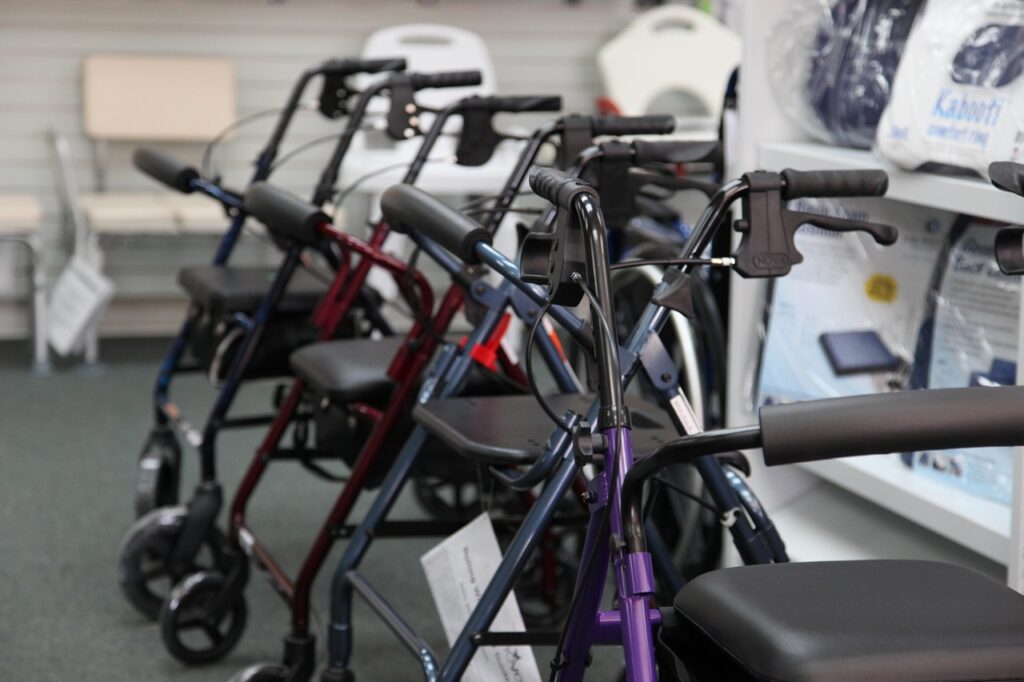 A row of walkers and rollators displayed in a medical supply store, representing different mobility aid options for seniors.