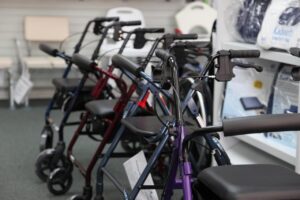 Essential Life Hacks for Seniors: Making Everyday Living Easier 11 A row of walkers and rollators displayed in a medical supply store, representing different mobility aid options for seniors.
