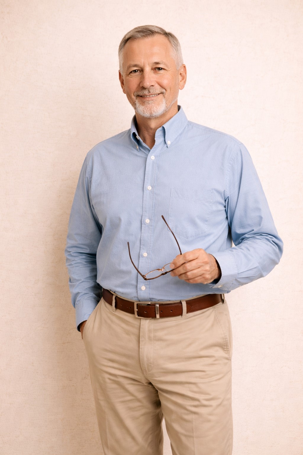Confident man over 60 holding glasses, representing flexible job and work options later in life
